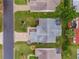 Aerial view of home with backyard seating, a patio, and mature landscaping at 7978 Se 174Th Belhaven Loop, The Villages, FL 32162