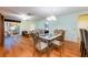 Dining area with stylish chairs, hardwood floors, and access to the living room and kitchen at 7978 Se 174Th Belhaven Loop, The Villages, FL 32162