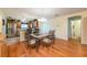 Dining area connecting to the kitchen, featuring hardwood floors and decorative table at 7978 Se 174Th Belhaven Loop, The Villages, FL 32162