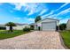 Charming single-story home with a brick driveway, well-manicured lawn, and inviting entrance at 7978 Se 174Th Belhaven Loop, The Villages, FL 32162