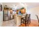 Kitchen with stainless steel appliances, wooden cabinets, a breakfast bar, and tile floors at 7978 Se 174Th Belhaven Loop, The Villages, FL 32162