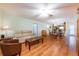 Bright and airy living room with hardwood floors, a comfortable sofa and ample natural light at 7978 Se 174Th Belhaven Loop, The Villages, FL 32162