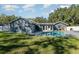 Backyard view featuring an in-ground pool and mature landscaping at 805 Leopard Trl, Winter Springs, FL 32708