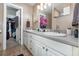 Bathroom with double sinks, white cabinetry, and a walk in closet at 805 Leopard Trl, Winter Springs, FL 32708