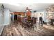 Dining area with stone fireplace, wood floors, and easy kitchen access at 805 Leopard Trl, Winter Springs, FL 32708