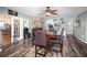 Dining area with stone fireplace, wood floors, and adjacent kitchen at 805 Leopard Trl, Winter Springs, FL 32708