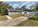 Exterior of home featuring solar panels, a long driveway, and desert landscaping at 805 Leopard Trl, Winter Springs, FL 32708