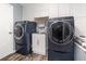 Modern laundry room with new washer and dryer, utility sink, and overhead cabinets at 805 Leopard Trl, Winter Springs, FL 32708