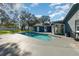 Backyard pool with concrete patio, in-ground spa, and mature trees at 805 Leopard Trl, Winter Springs, FL 32708