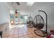 Bright sun room with tile floors, ceiling fans, and hanging swing chairs at 805 Leopard Trl, Winter Springs, FL 32708