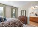 Bedroom with wooden dresser and ensuite bathroom entrance at 8276 Maritime Flag St # 110, Windermere, FL 34786