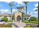 Impressive clubhouse entrance framed by palm trees, and well-manicured landscaping at 8276 Maritime Flag St # 110, Windermere, FL 34786