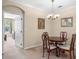 The dining room is adjacent to another room and features a chandelier and neutral decor at 8276 Maritime Flag St # 110, Windermere, FL 34786