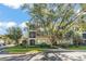 The building's exterior features lush landscaping, palm trees and ample parking at 8276 Maritime Flag St # 110, Windermere, FL 34786