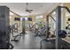 Well-equipped gym featuring modern machines, ample natural light, and a ceiling fan at 8276 Maritime Flag St # 110, Windermere, FL 34786