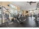 Spacious gym with varied machines, wall mirrors, ceiling fans, and large windows at 8276 Maritime Flag St # 110, Windermere, FL 34786