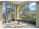 Enclosed patio with outdoor table provides serene views of lush greenery and community at 8276 Maritime Flag St # 110, Windermere, FL 34786