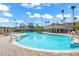 Beautiful community pool with palm trees and inviting seating areas, perfect for relaxation at 8276 Maritime Flag St # 110, Windermere, FL 34786