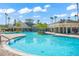 Stunning community pool area with lush landscaping, palm trees, and inviting lounge spaces at 8276 Maritime Flag St # 110, Windermere, FL 34786