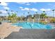 Resort-style pool with palm trees, lounge chairs, and well-maintained landscaping at 8276 Maritime Flag St # 110, Windermere, FL 34786