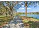 Scenic walking path lined with trees and a tranquil lake view, perfect for leisurely strolls and enjoying nature at 8276 Maritime Flag St # 110, Windermere, FL 34786