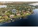 Stunning aerial view showcases lakefront living with lush landscaping, private docks, and elegant homes along the shoreline at 9224 Bentley Park Cir, Orlando, FL 32819