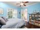 Cozy bedroom with window, shelving and hardwood flooring at 9224 Bentley Park Cir, Orlando, FL 32819