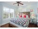 Comfortable bedroom with wood floors, large windows, and bright neutral walls at 9224 Bentley Park Cir, Orlando, FL 32819