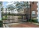 View of the Bentley Park entrance gate framed by a brick structure and featuring wrought iron detailing at 9224 Bentley Park Cir, Orlando, FL 32819