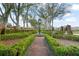 Beautiful brick-paved path with manicured hedges leads to a prominent clock tower in a well-maintained community at 9224 Bentley Park Cir, Orlando, FL 32819