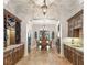 Dining area features wooden cabinets, wine racks and chandelier lighting, perfect for hosting elegant meals at 9224 Bentley Park Cir, Orlando, FL 32819