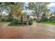 Elegant neighborhood entrance featuring brick pillars, lush landscaping, and a charming water fountain at 9224 Bentley Park Cir, Orlando, FL 32819