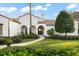 Inviting home features verdant front yard landscaping and a charming stone pathway to the beautiful front entrance at 9224 Bentley Park Cir, Orlando, FL 32819