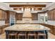 An open concept kitchen showcases a large center island, custom cabinetry, and pendant lighting at 9224 Bentley Park Cir, Orlando, FL 32819