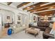 Open-concept living room with high ceilings, exposed beams, and travertine flooring at 9224 Bentley Park Cir, Orlando, FL 32819