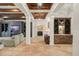 Inviting living room with beamed ceilings, custom built-ins, and travertine floors at 9224 Bentley Park Cir, Orlando, FL 32819