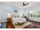 Light-filled main bedroom with hardwood floors and a large window view at 9224 Bentley Park Cir, Orlando, FL 32819