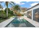 Backyard pool with a jacuzzi, palm trees, and lounge chair at 9224 Bentley Park Cir, Orlando, FL 32819