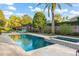 Resort-style backyard with a sparkling pool, spa, and lush landscaping at 9224 Bentley Park Cir, Orlando, FL 32819