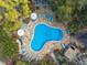 Aerial view of community pool area with lounge chairs and umbrellas providing an ideal recreational space at 940 Douglas Ave # 189, Altamonte Springs, FL 32714