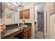 Bathroom featuring granite counters, vanity, cherry cabinets, and stylish fixtures, providing modern comfort at 940 Douglas Ave # 189, Altamonte Springs, FL 32714