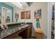 Bathroom featuring granite vanity, bright decor, and a framed mirror, creating a pleasant space at 940 Douglas Ave # 189, Altamonte Springs, FL 32714