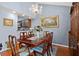 Formal dining room features a chandelier and a large painting, with wood floors and seating for six at 940 Douglas Ave # 189, Altamonte Springs, FL 32714