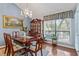 Elegant dining room with hardwood floors, a chandelier, and large window at 940 Douglas Ave # 189, Altamonte Springs, FL 32714