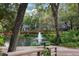 Picturesque pond with a fountain, surrounded by lush greenery and trees, creating a serene outdoor setting at 940 Douglas Ave # 189, Altamonte Springs, FL 32714