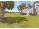 Home exterior showing a spacious backyard with lush green grass and mature trees at 9516 Darien Ave # 9516, Orlando, FL 32817