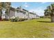 Exterior view of townhomes featuring well-manicured landscaping and neutral color palette at 9516 Darien Ave # 9516, Orlando, FL 32817