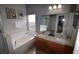 Bright bathroom highlighting double sink vanity, soaking tub, picture window, and modern fixtures at 954 Lockbreeze Dr, Davenport, FL 33897