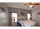 Comfortable bedroom with a ceiling fan, bedside tables, and soft, natural lighting at 954 Lockbreeze Dr, Davenport, FL 33897