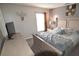 Inviting bedroom showcasing a comfortable bed, dresser, television and soft natural light at 954 Lockbreeze Dr, Davenport, FL 33897